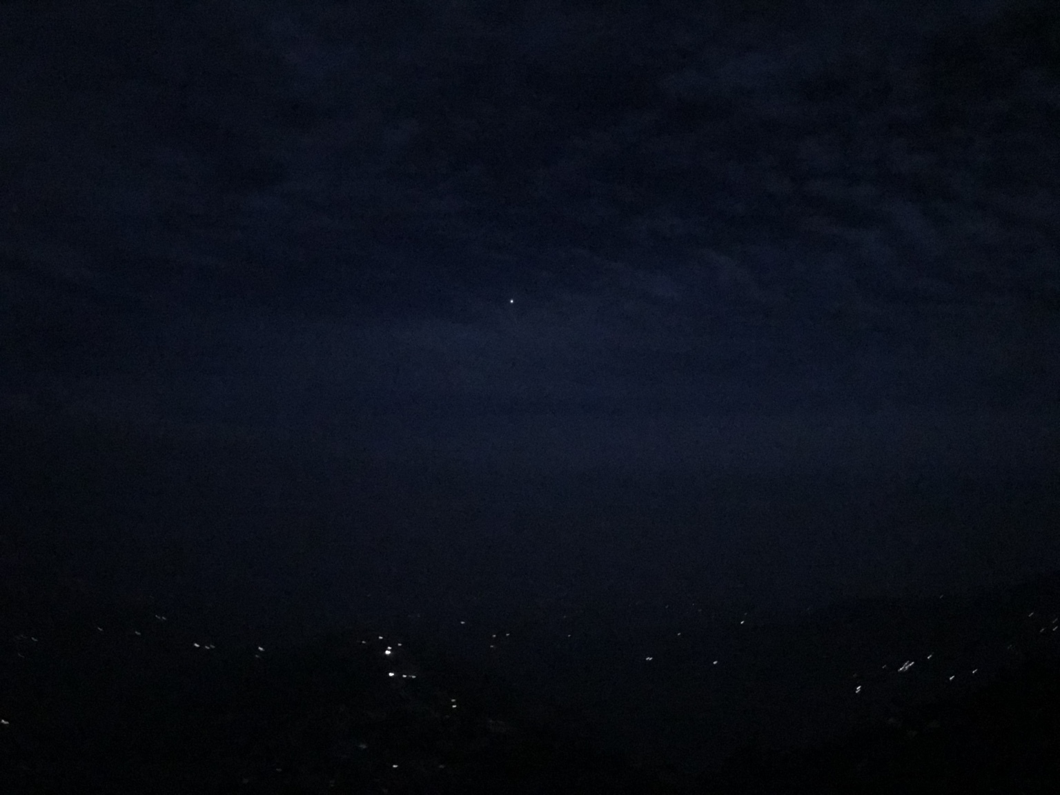 Pre-dawn darkness at Nagarkot: a single star, village lights below